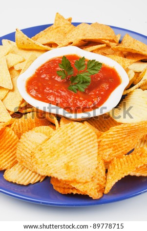 Fried potato chips with homemade salsa dip sauce