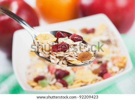Cereal muesli with dried fruit in a spoon, selective focus