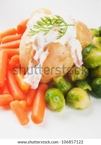 Jacket potato with cream sauce, baby carrot and brussels sprout