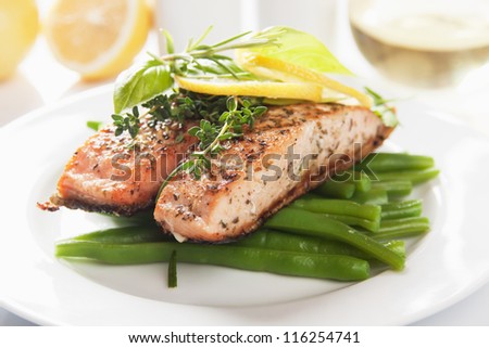 Grilled salmon steak with lemon and vegetables