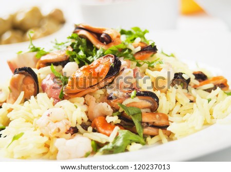 Cooked rice, risotto with mussels and shrimps