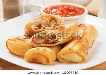 Fried asian egg rolls with hot pepper ant tomato sauce