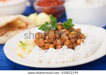 Chana masala, chickpeas with cooked rice, classic indian meal