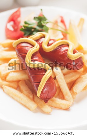 Fried sausage with hot mustard and french fries