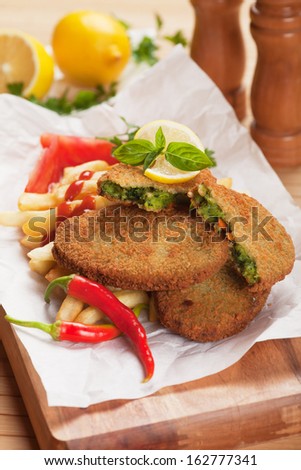 Breaded vegetable steak or burger with french fries