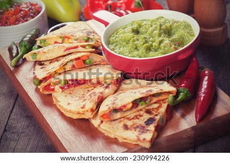 Mexican quesadillas with cheese, vegetable and guacamole dip