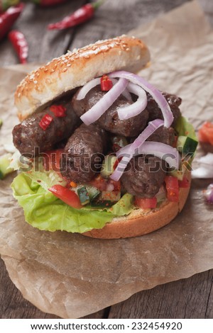 Turkish kebab grilled meat in burger bun with onion and salad