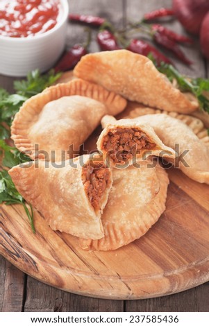 Fried empanada stuffed with ground beef, classic latin american appetizer