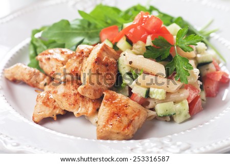 Chicken and pasta salad with tomato and cucumber