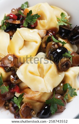 Italian tortellini pasta salad with parsley and green olives