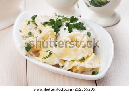 Italian tortellini pasta with cheese sauce and parsley