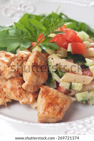 Chicken and pasta salad with tomato and cucumber