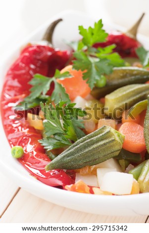 Healthy vegan meal with okra, bell pepper and cooked vegetables