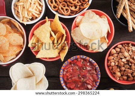 Tortilla chips and other salty snacks with homemade salsa