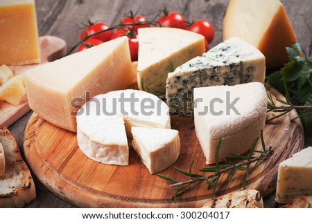 Assorted cheese on wooden platter, rich and healthy breakfast or snack food