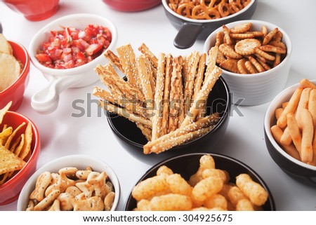 Salty grissini sticks with sesame seed and other savory snack