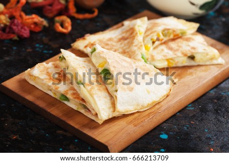 Mexican quesadillas, cheese filled tortilla wraps with salsa and guacamole