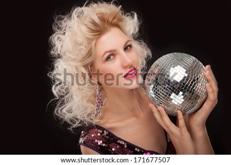 face of young woman with fashionable make-up and disco ball in hands