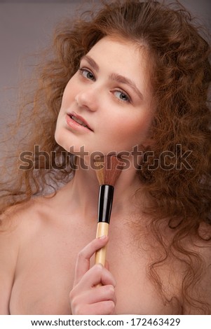 Makeup. Cosmetic. Base for Perfect Make-up.Applying Make-up, red hair girl with curly hair