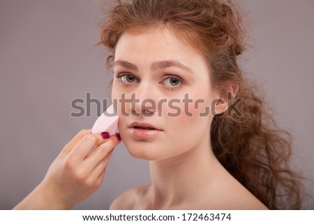 Makeup. Cosmetic. Base for Perfect Make-up.Applying Make-up, red hair girl with perfect skin