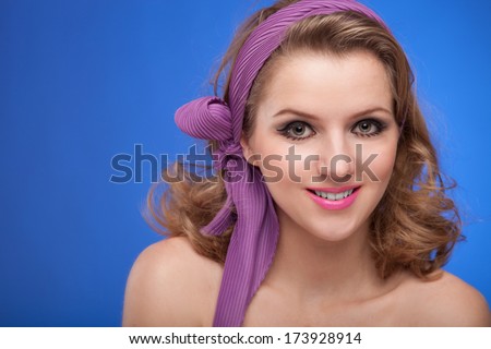 Retro portrait of a beautiful woman. Vintage style. Fashion photo. Blue background. Haircut. Hairstyle. Professional Makeup. Style Woman
