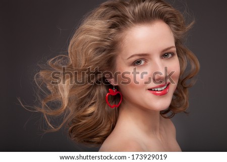Beautiful young woman with long brown hair. Pretty model poses at studio. Haircut. Hairstyle. Professional Makeup. Style Woman