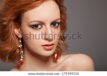 Red Hair. Fashion Woman Portrait. Beauty Model Girl with Luxurious Hair, Make up and Accessories. Hairstyle. Holiday Makeup. Red lipstick