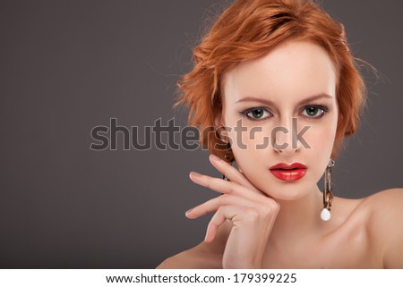 Red Hair. Fashion Woman Portrait. Beauty Model Girl with Luxurious Hair, Make up and Accessories. Hairstyle. Holiday Makeup. Red lipstick