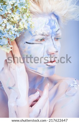 beauty woman with face art and flowers