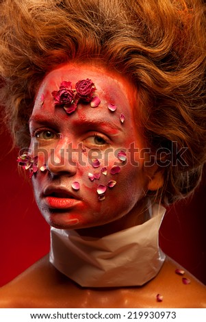 girl with red and gold color face art