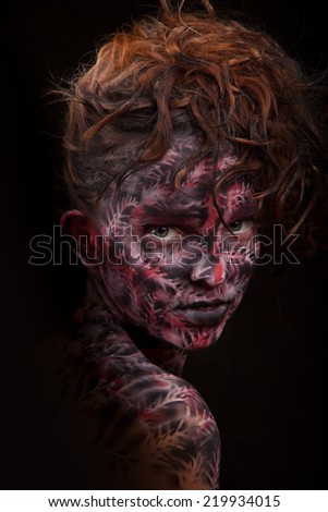 Portrait of the beautiful girl with dark painted face art