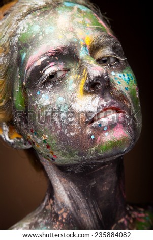 Elegant woman portrait with face art on face. color paint on body and face.