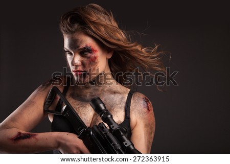 Riot girl with sniper gun close up portrait. With blood and wound on face.