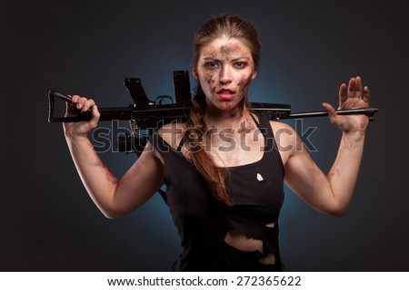 Sexy woman with weapon on dark background. Riot girl.