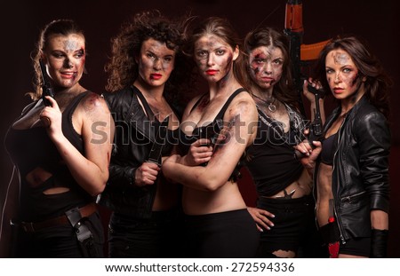 Group of sexy woman like riot woman. Girls with weapon, gun, rifle and knife. With blood on face.