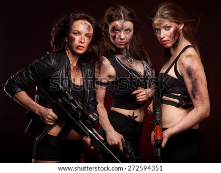 Group of sexy woman like riot woman. Girls with weapon, gun, rifle and knife. With blood on face.