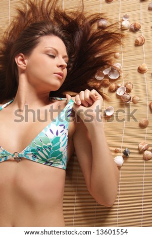 A beautiful girl in bikini laying
