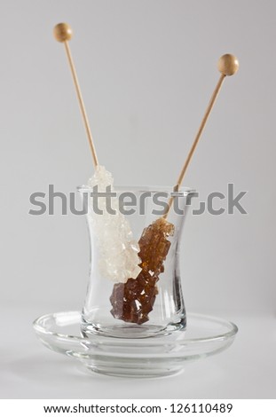 Sticks of white sugar and cane sugar