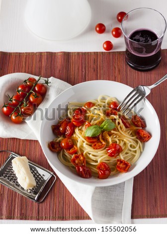 Plate of spaghetti sauce with fresh cherry tomatoes.
