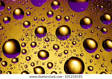 background of purple and gold drops of water