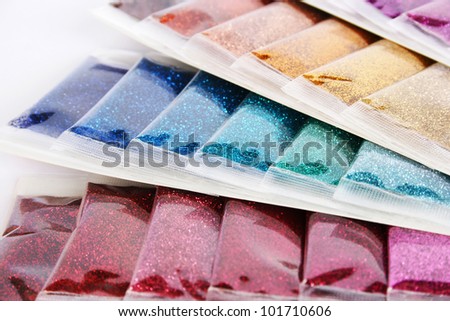 Colorful nail glitters closeup picture.