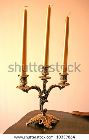 Three nice candles on a luxurious candle-stick.