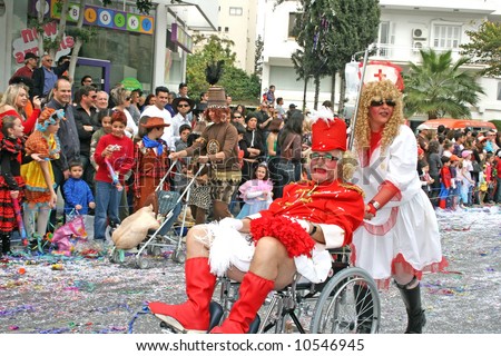 Funny couple in cheerleader and nurse costumes in Cyprus carnival parade.