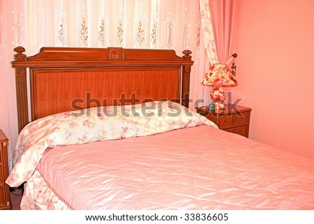 Beautiful pink bedroom with luxurious curtains.