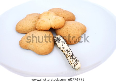 Assorted cookies on plate isolated on white background.