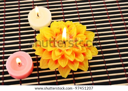 Colorful  candles isolated on bamboo  background.
