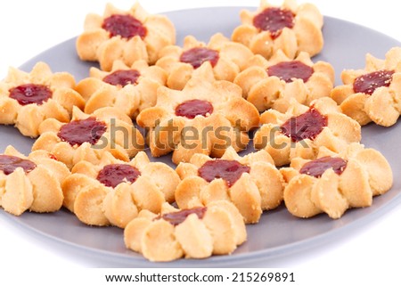 Sweet cookies with jam on gray plate isolated on white background.