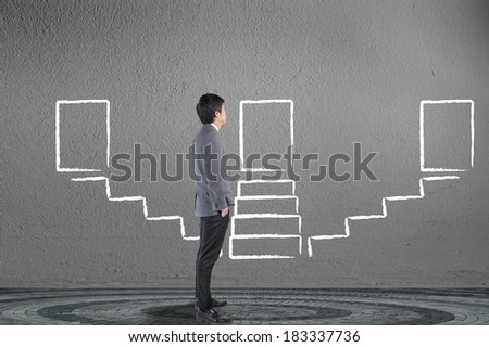Businessman looking and drawing stairway for success solution concept