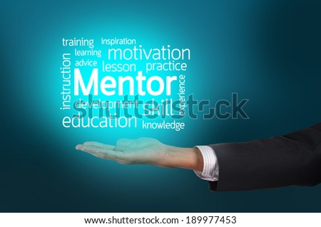 Businessman hand holding word tags of Mentor