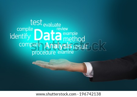 Businessman hand holding word tags of Data Analysis